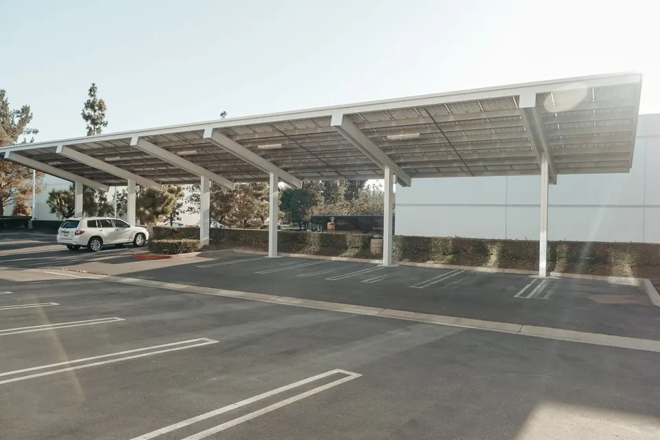 Solar panels installed over a parking lot, showcasing clean energy innovation outdoors.